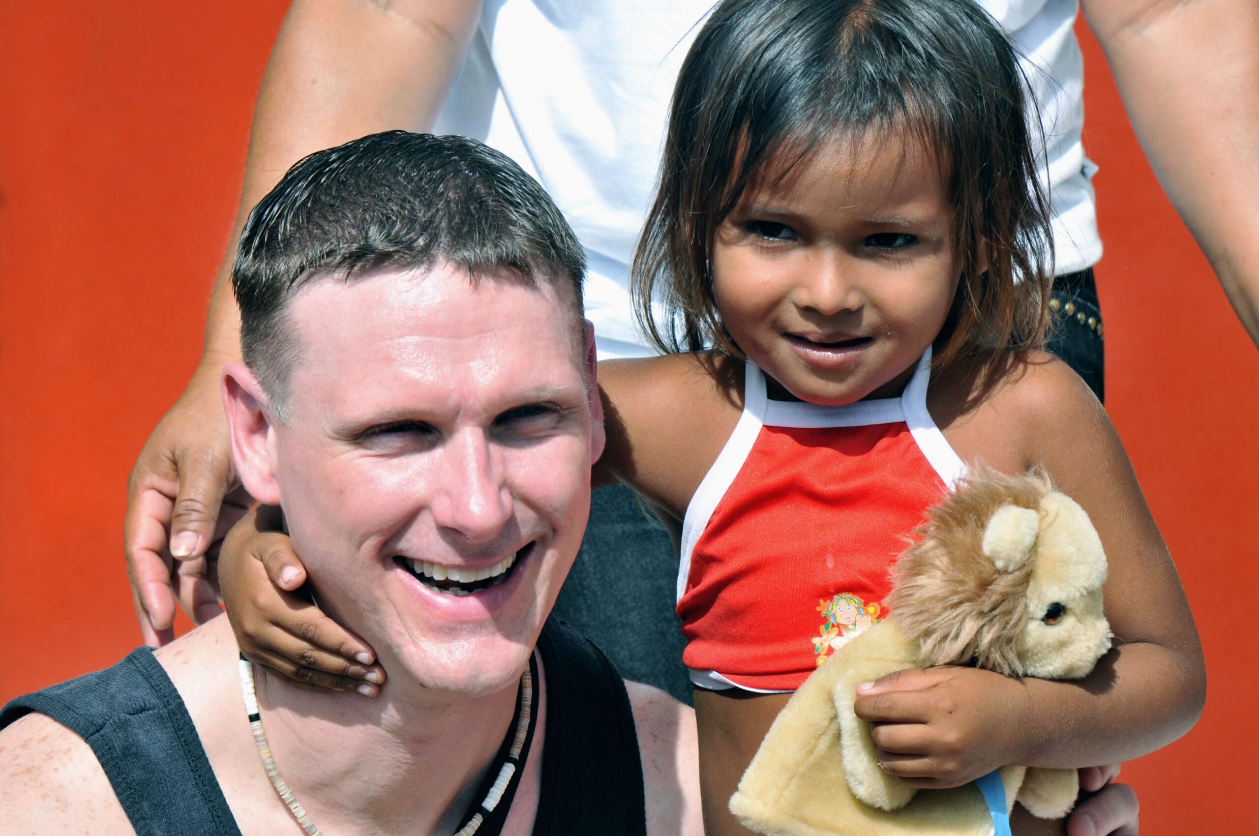 Adventures for Solo Travelers guest smiles with a local child in Brazil, highlighting cultural connection on a small group tour for solo travelers.