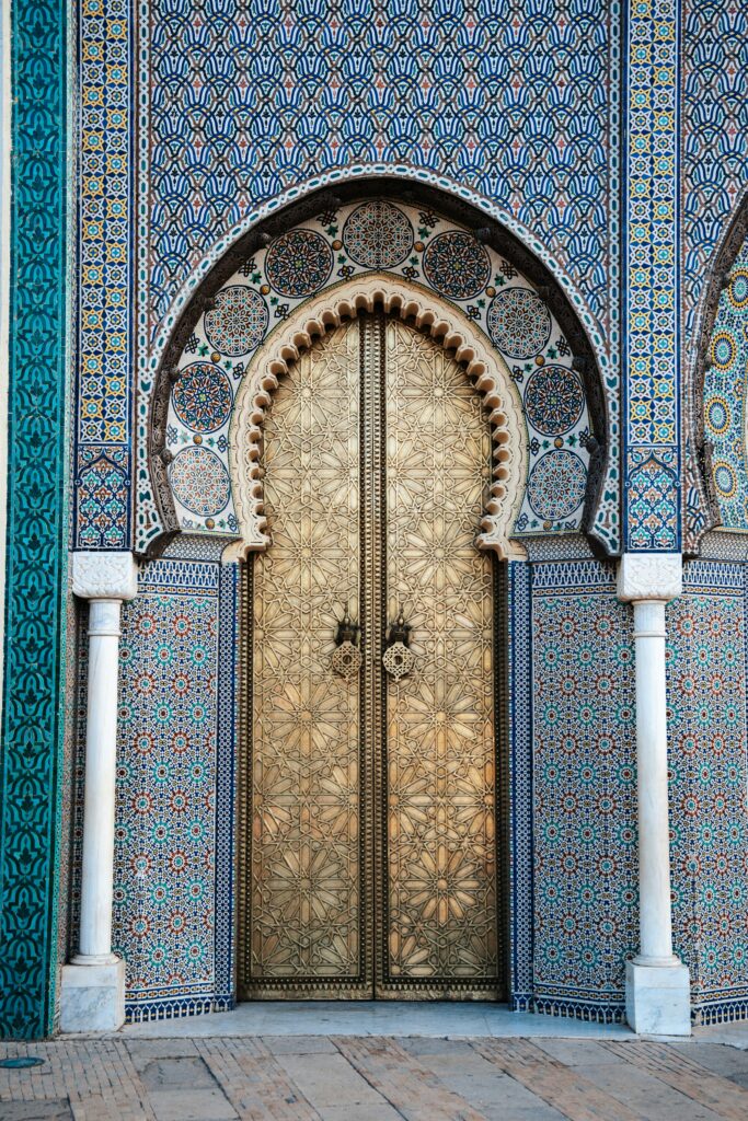 Ornate carved doorway framed by colorful Islamic mosaic tiles along the Silk Road, showcasing Central Asia's rich architectural heritage on a guided small group adventure for solo travelers. Adventures for Solo Travelers by Suzy Davis