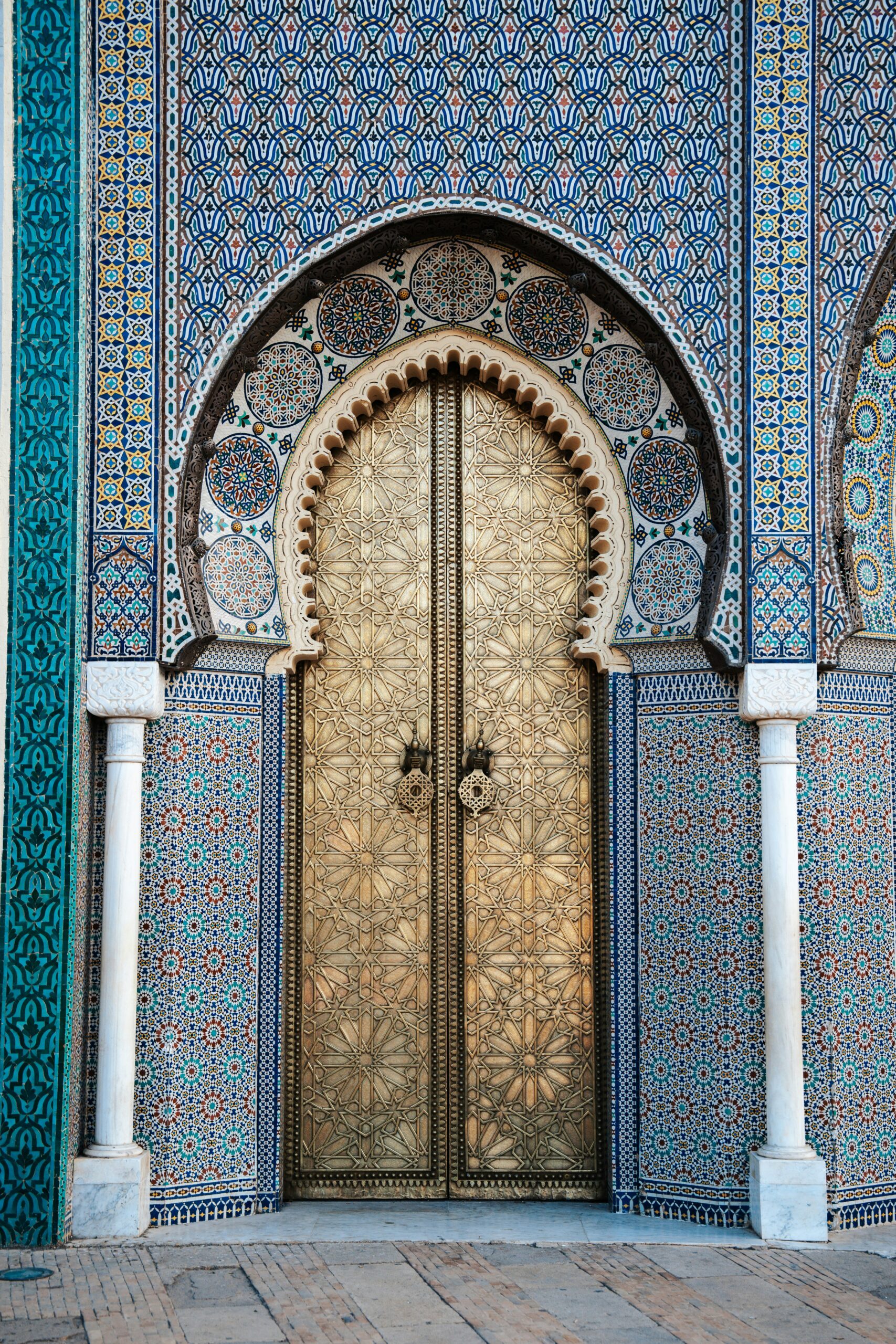 Ornate carved doorway framed by colorful Islamic mosaic tiles along the Silk Road, showcasing Central Asia's rich architectural heritage on a guided small group adventure for solo travelers. Adventures for Solo Travelers by Suzy Davis
